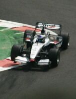 Raikkonen bouncing over the curbs at the Bus Stop